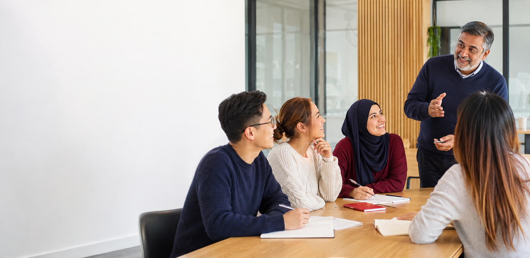 A diverse group of adults taking part in a communication class